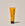 A tube of ACURE Brightening Facial Scrub against a neutral background.